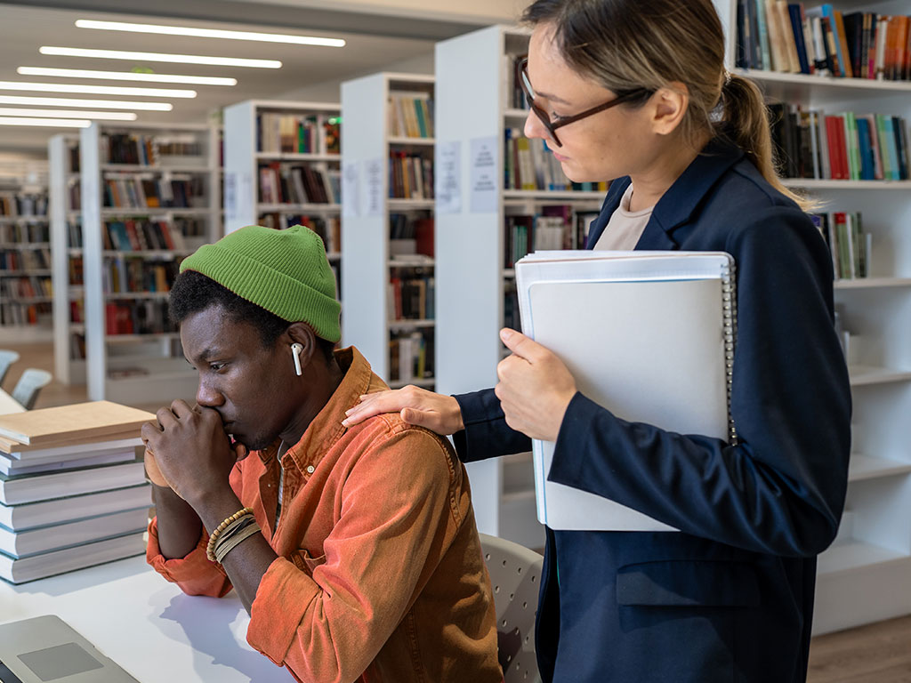 Student with tutor in library