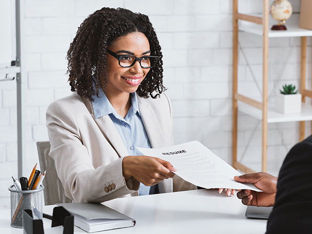 Woman handing in resume