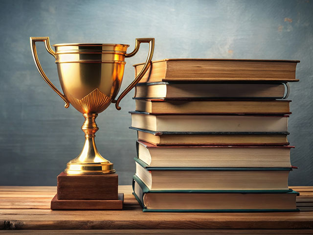 Trophy next to stack of books