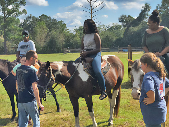 Outdoor club going horsebackriding