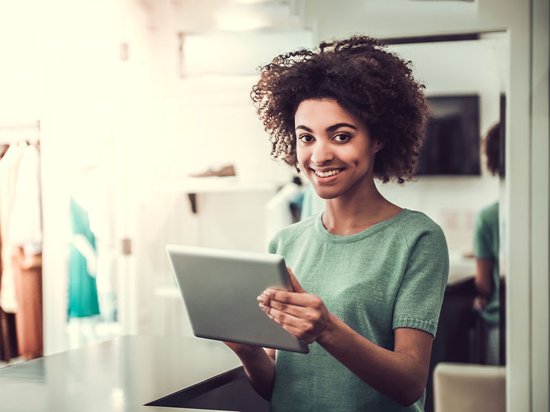 Young woman with a part time job as a clothing sales assistant