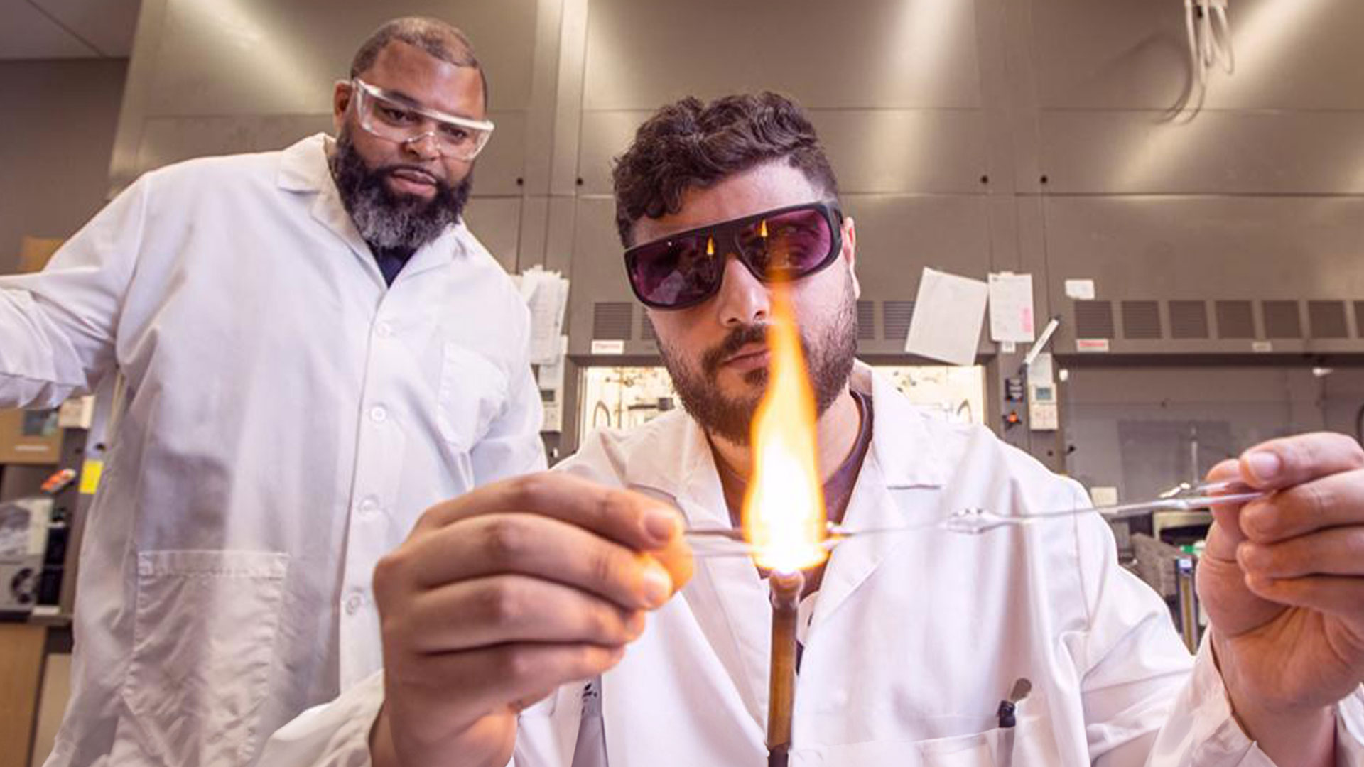 Grad student Shefik Bowen, left, watches as fellow grad student Omar Taleb works on anionic polymeritation synthesis of block-copolymers in the environmental lab at AME. (M Wallheiser/FAMU-FSU Engineering)