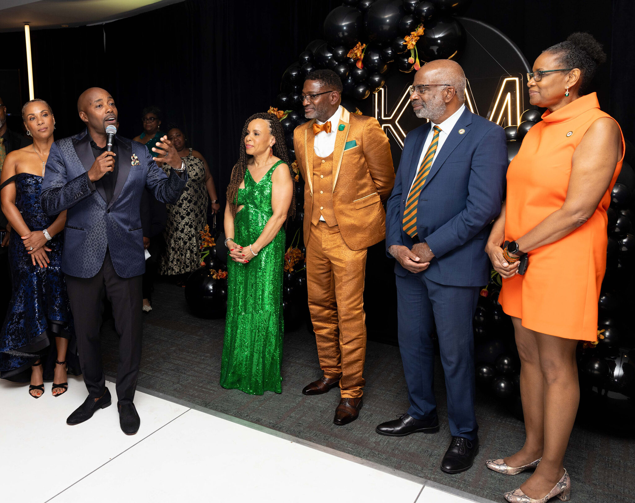 During the Winning Foundation fundraiser, film mogul Will Packer addresses Kimberly Godwin Manning and Derrick Manning as President Robinson and Sharon Robinson look on. (Credit: Christian Whittaker) 