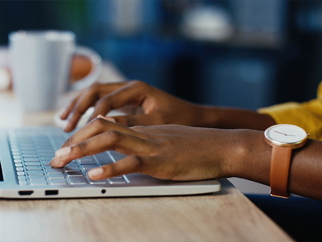 Woman typing on computer