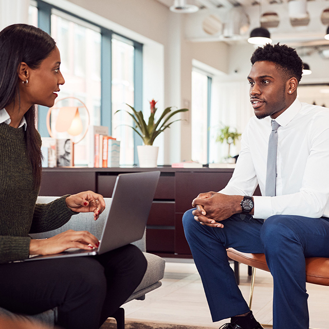 young male student having a meeting with his advisor 