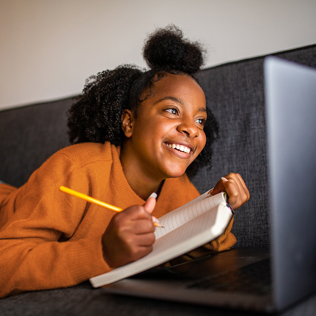 young african american woman using a laptop to register for classes