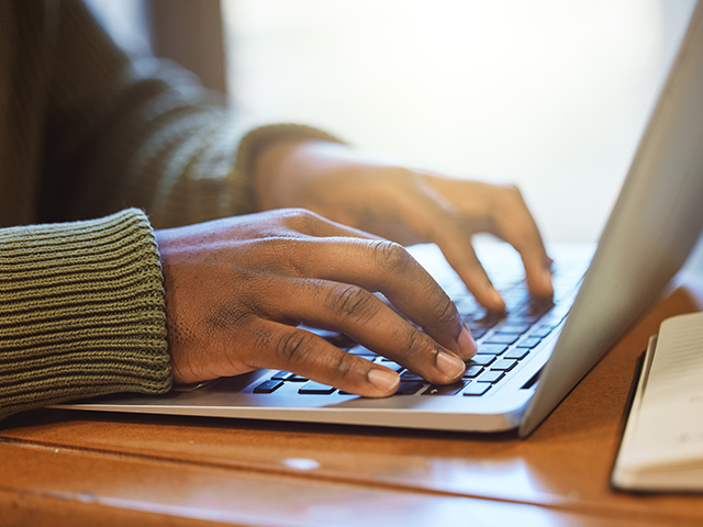 hands on laptop typing