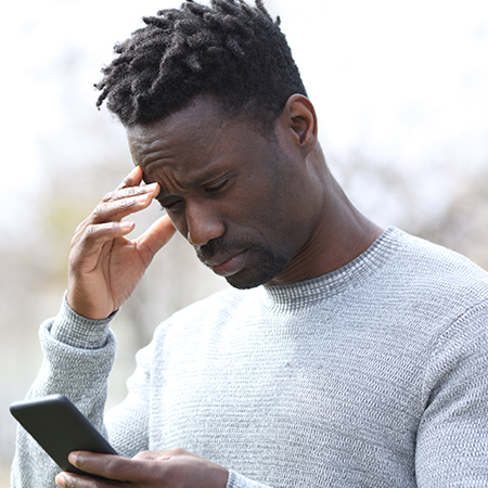 Man looking at phone concerned