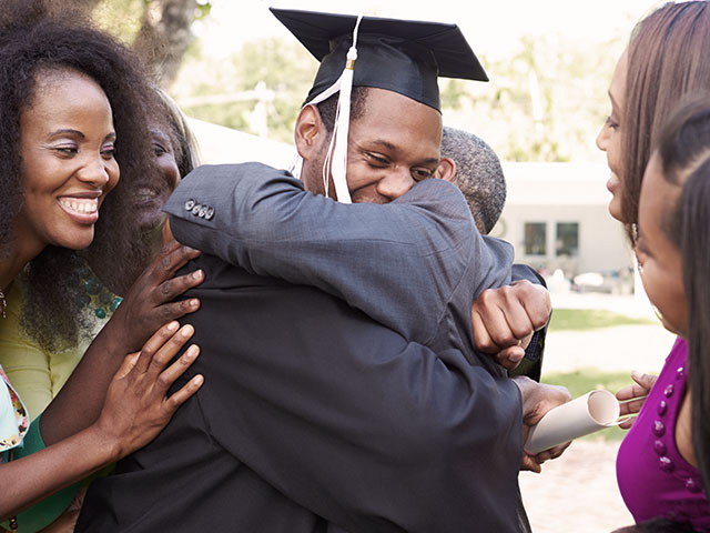 Family celebrating recently graduated student