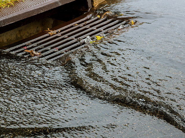 Water gushing from storm sewer following very heavy rainfall