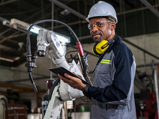 Man working on robotic arm