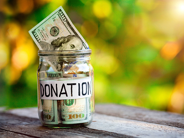 Jar of money with label that reads "donations" in capitol letters