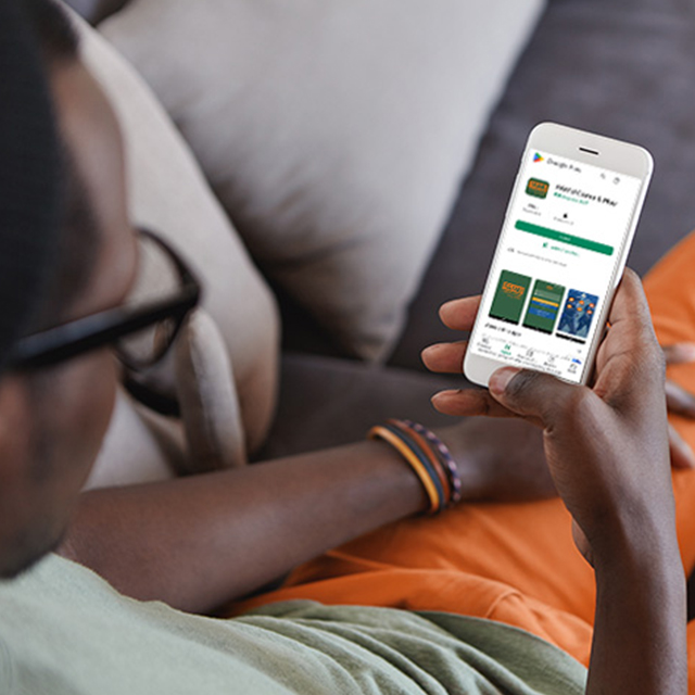 young man doenloading an app from the app store on his cell phone