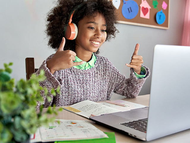 African American female Student using sign language during an online video call.